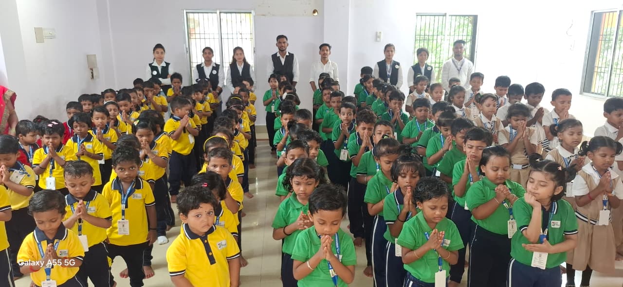 Children standing together for morning prayer