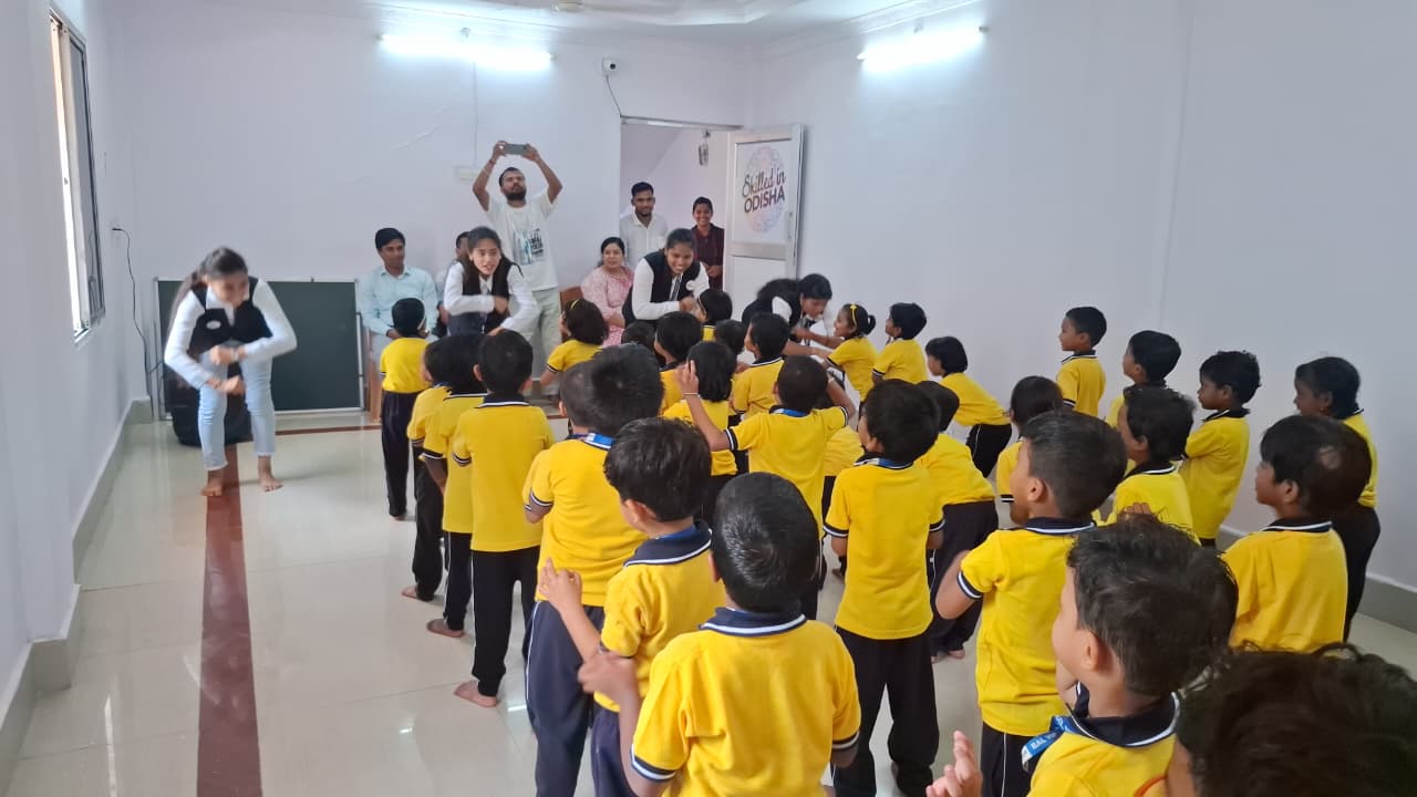Teachers leading children in a movement and learning activity at Bal Vidyalaya