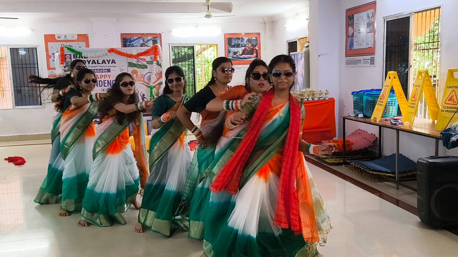 Educators performing a tricolour dance at the Independence Day programme